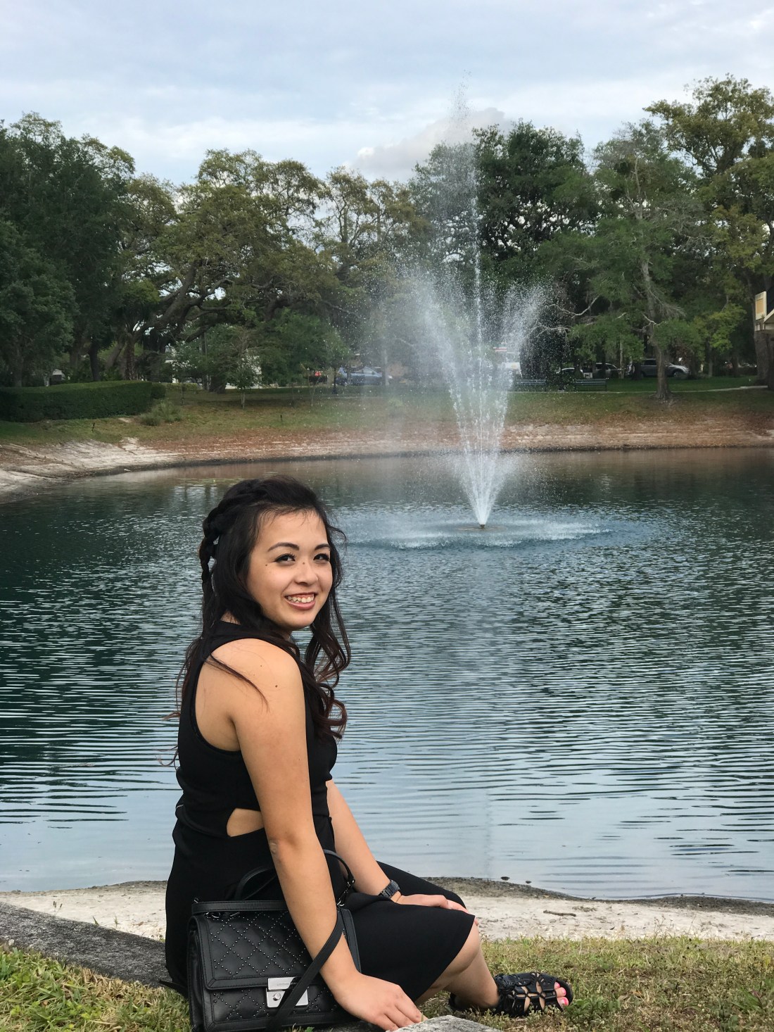 Sitting lakeside in a black dress