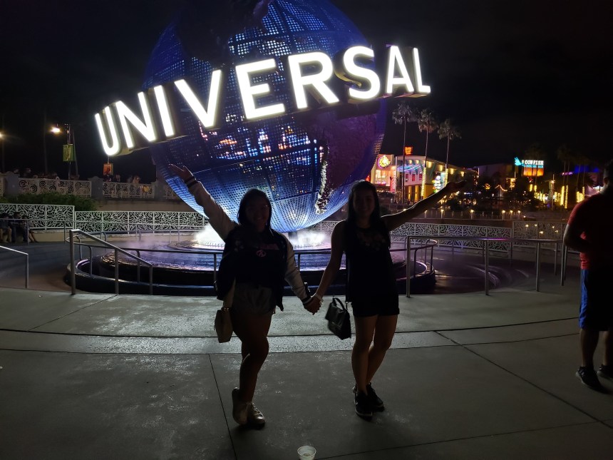 My friend and I standing in front of the Universal logo together.