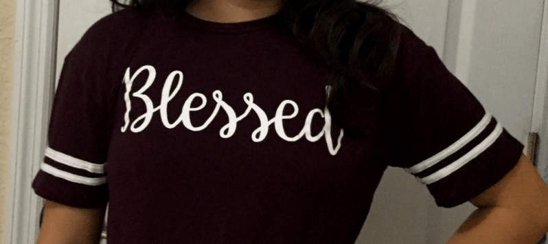 Maroon colored shirt with the word "Blessed"