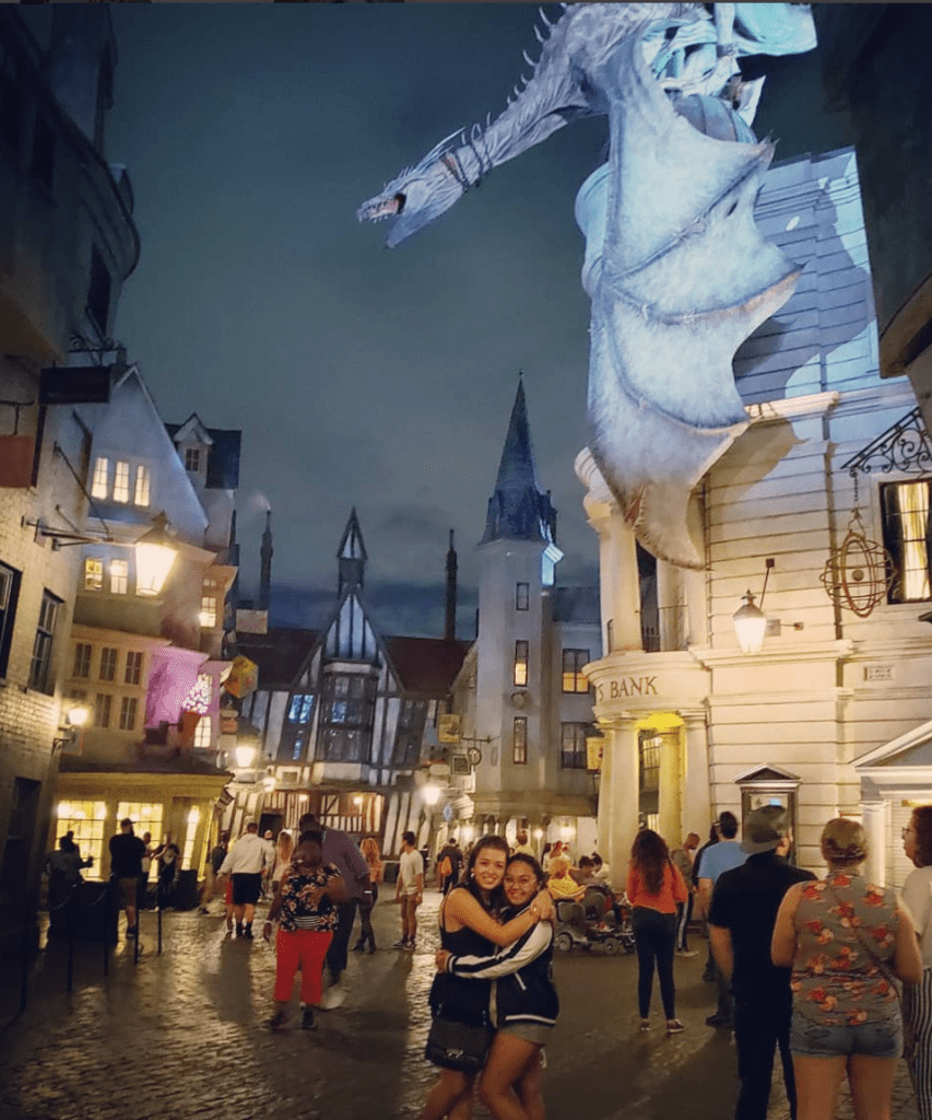 Me and my friend at Diagon Alley underneath the dragon that broke out of Gringotts Bank.