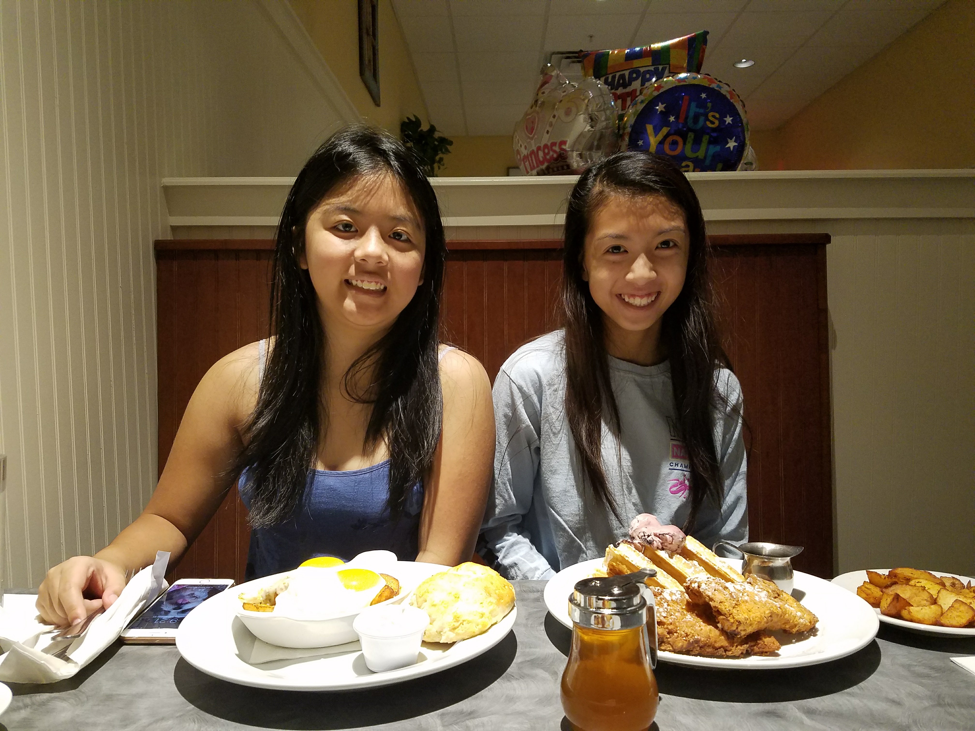 This is a photo of my sisters sitting together during a meal we shared.