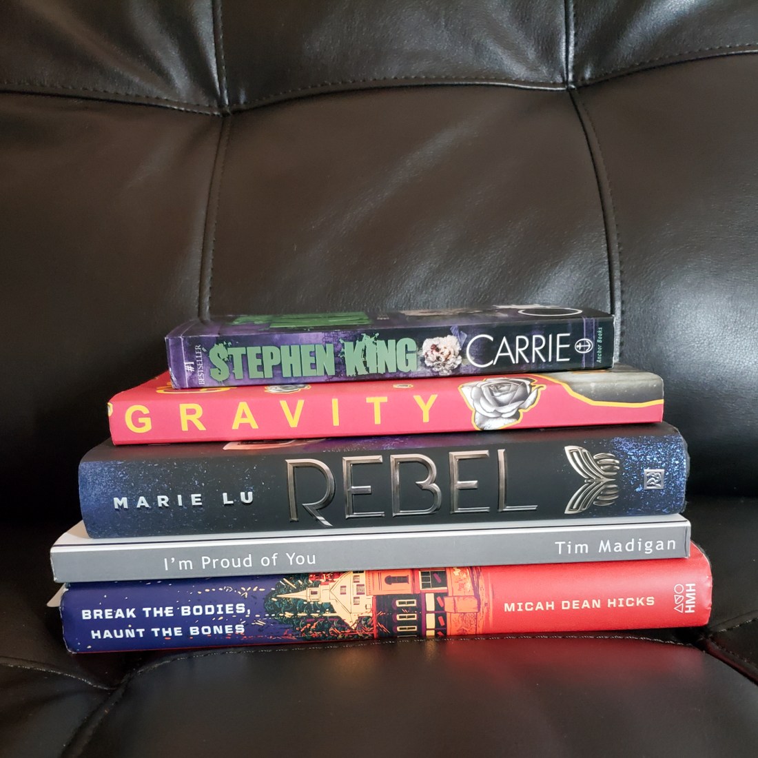 There are five books at the top of my reading list this month, and they are all stacked up right here.