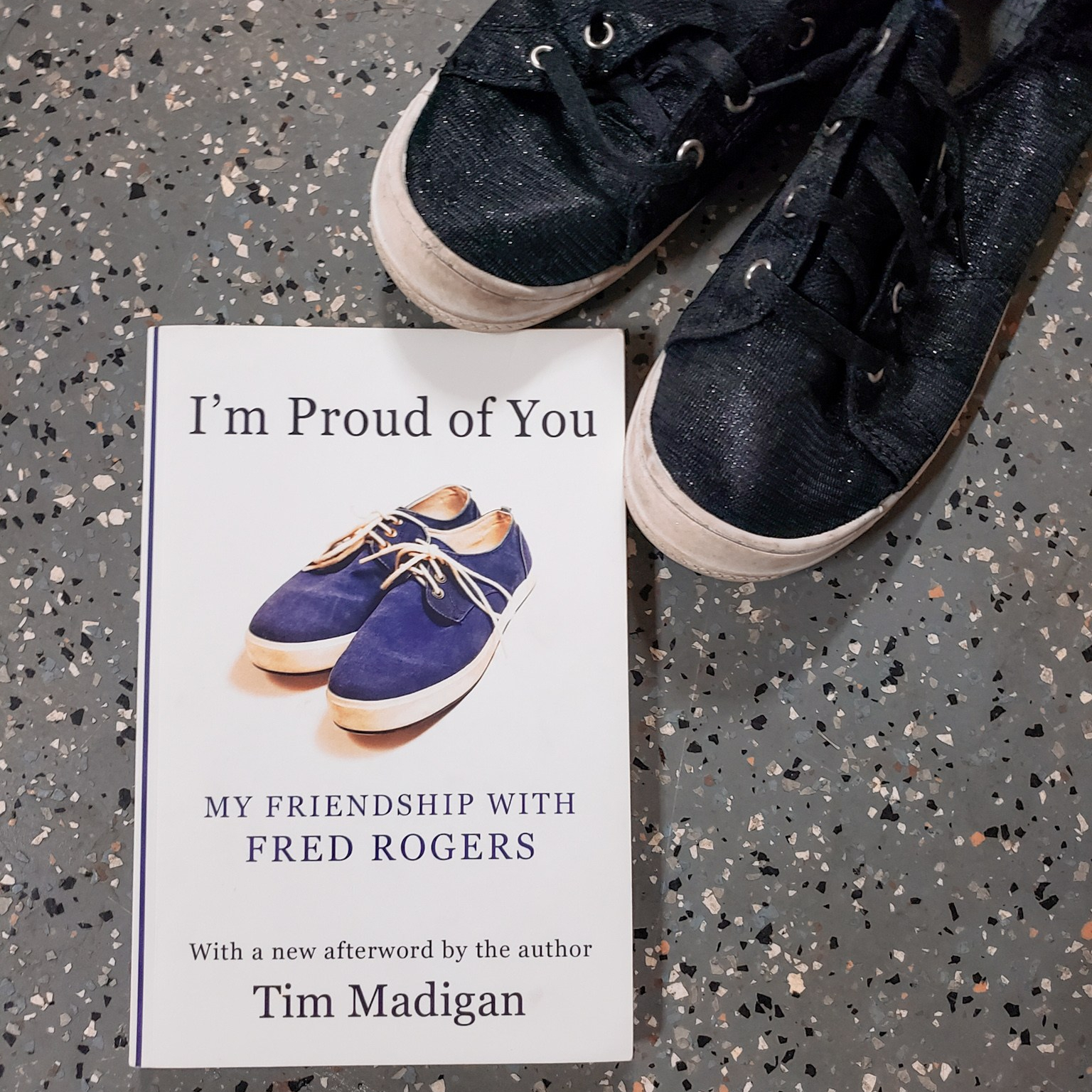 A photo of my copy of I'm Proud of You by Tim Madigan, featuring a pair of my shoes.