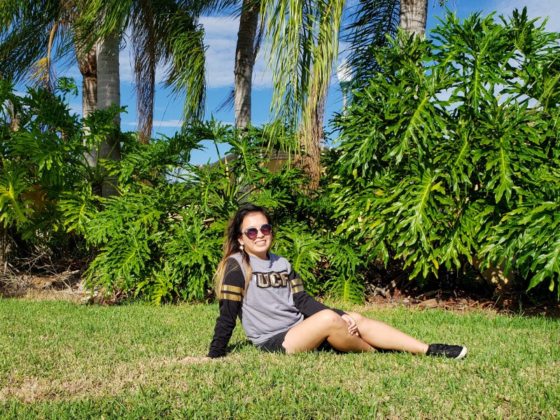 Me sitting on a field of green on game day.