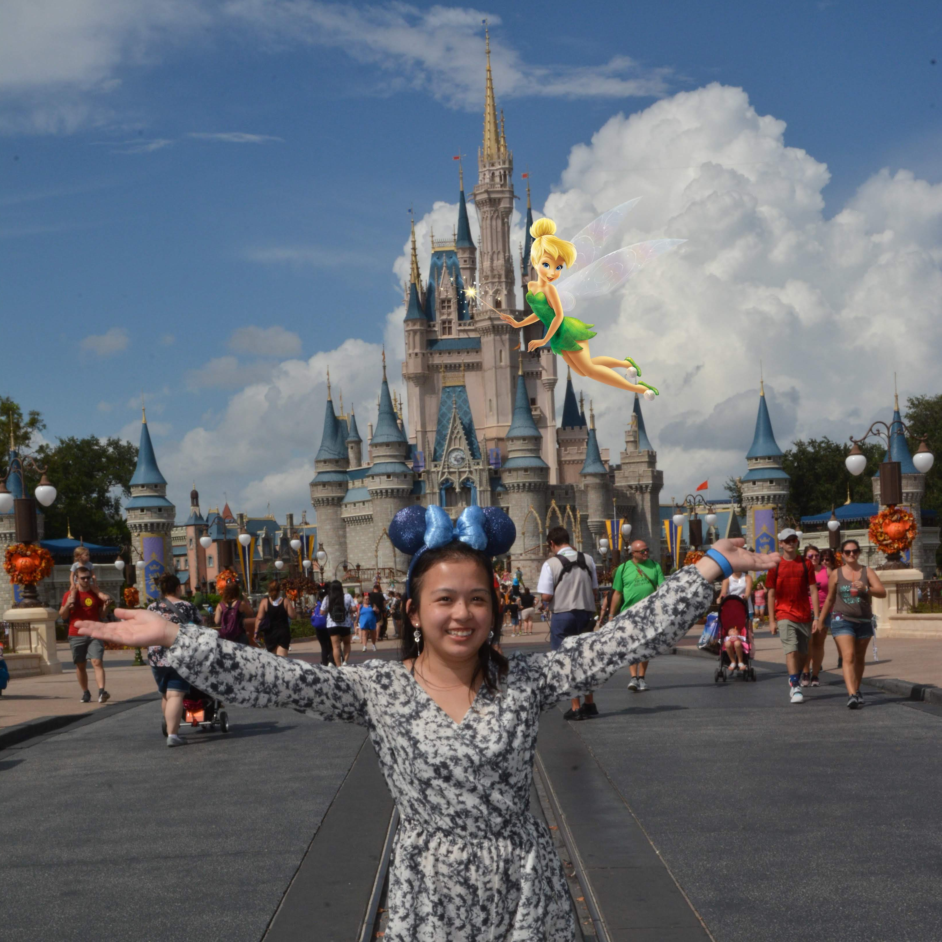 A photo of me and my mouse ears at Magic Kingdom. Tinker Bell is flying around spreading all the magical pixie dust.