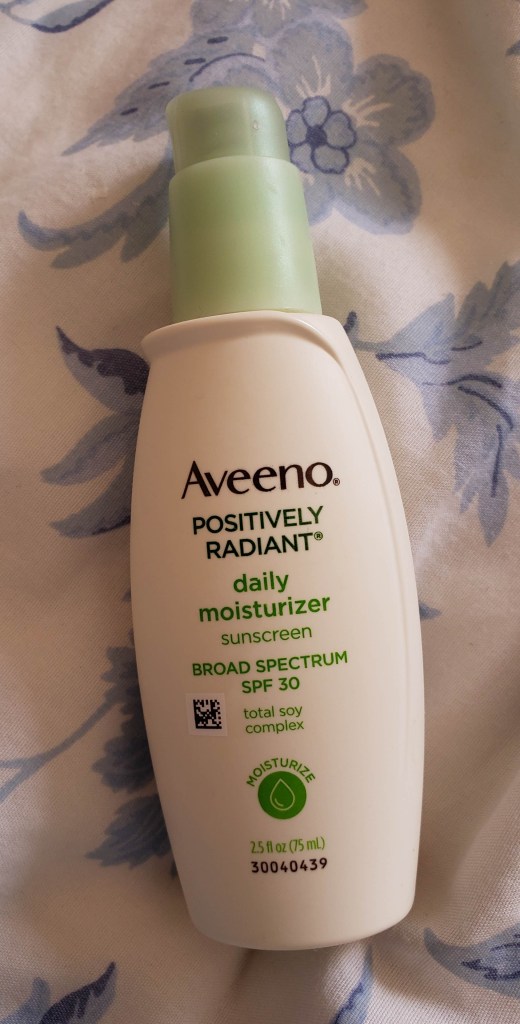 The Aveeno Positively Radiant bottle is small enough to fit in the palm of my hand. It's white with green accents, and it comes in a box so you might not see the bottle until you've purchased it and opened it up.