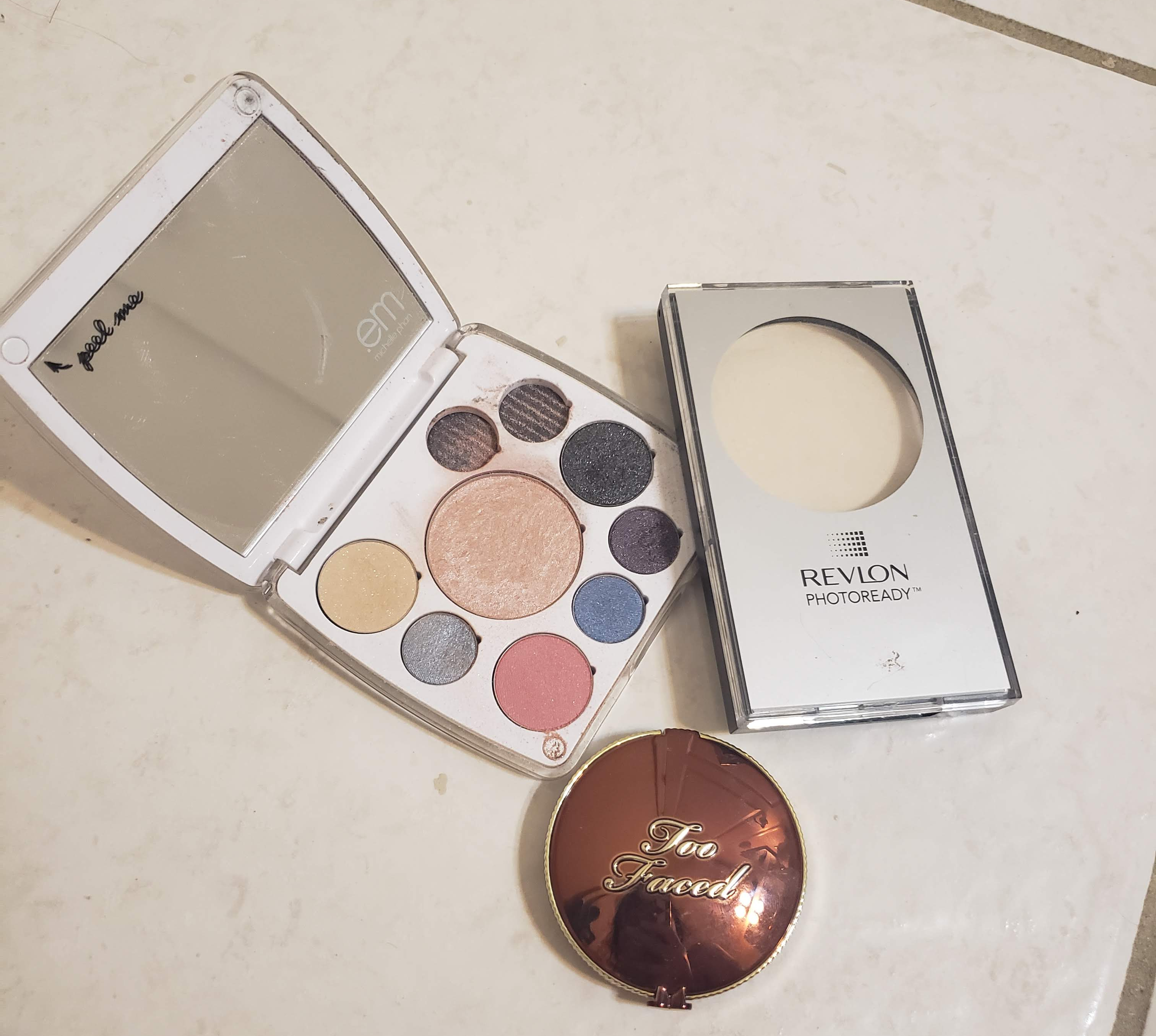 Pictured: A compact by EM Cosmetics, Revlon PhotoReady Translucent Finisher, and Too Faced Chocolate Soleil Bronzer.