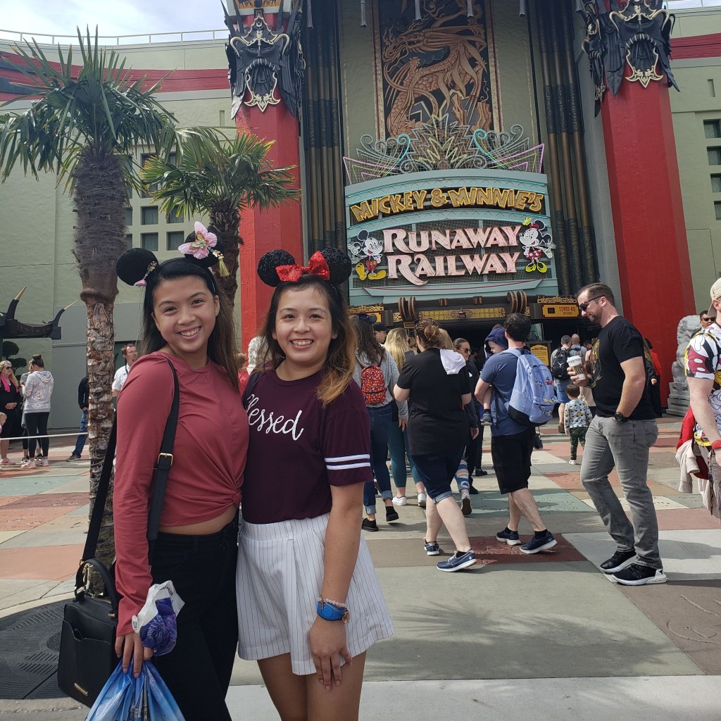 Here's a photo of me and my sister in front of the Mickey and Minnie's Runaway Railway attraction before the world shut down.