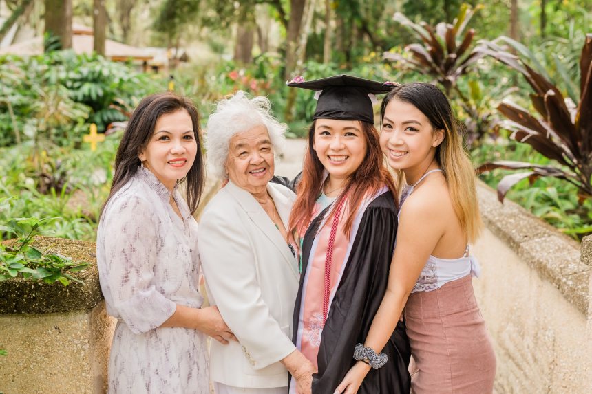 When we had the photo shoot, my grandma was insistent that we get a photo together in my graduation gear. My grandma herself was never literate, and my mom barely made it for school. My sister is standing behind me, and she's in the process in completing her college education now.