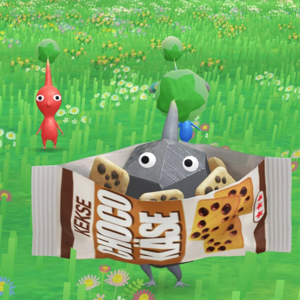One Red Pikmin in the background, and one Rock Pikmin in the foreground wearing a cookie wrapper.