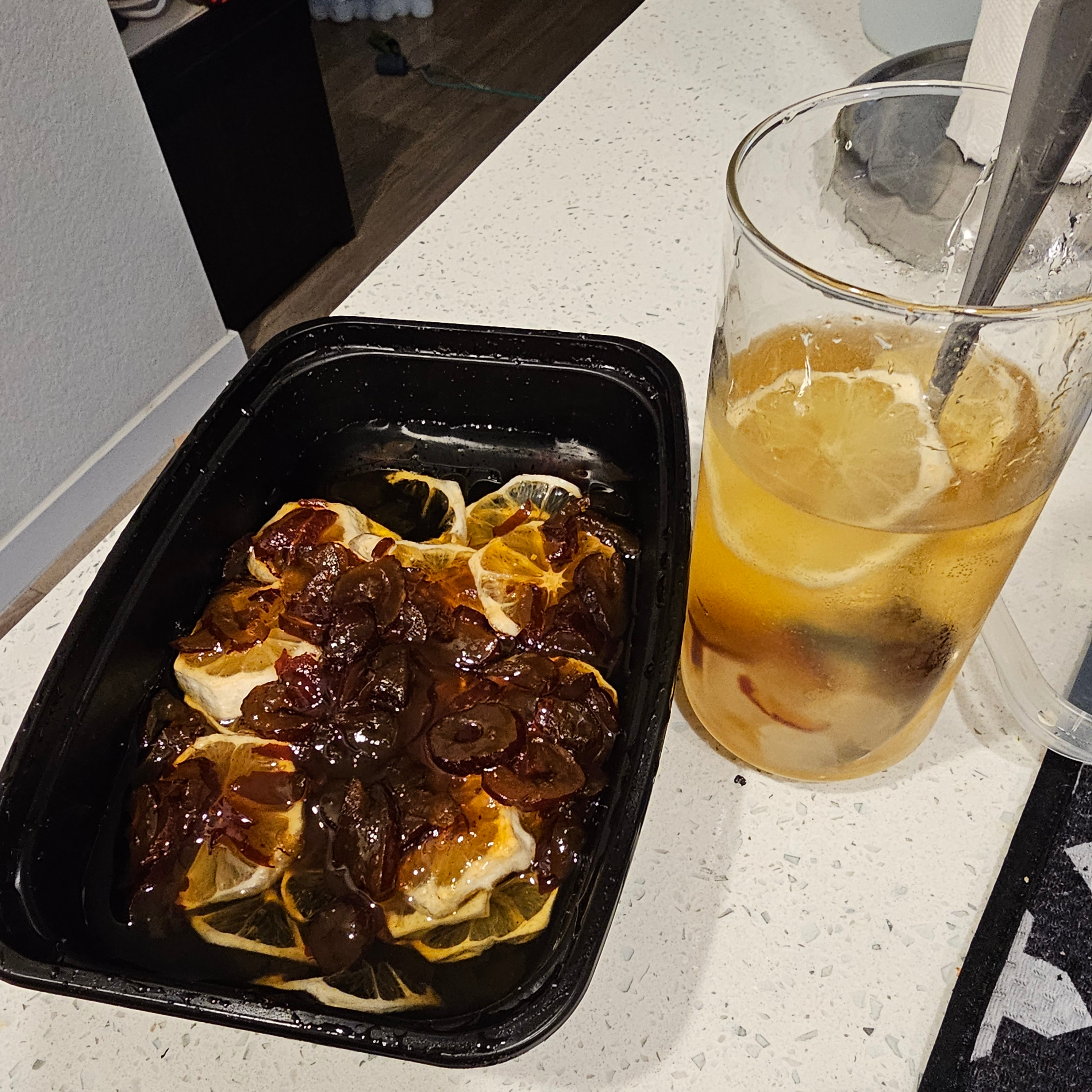 In the black container is the lemonade syrup that I tried to concoct. It consists of rock sugar and lemon slices. Instead of a passionfruit layer on top, I chose to use a honey jujube mixture that I had on hand instead. The glass to the right contains a few spoons of the mixture in sparkling water.