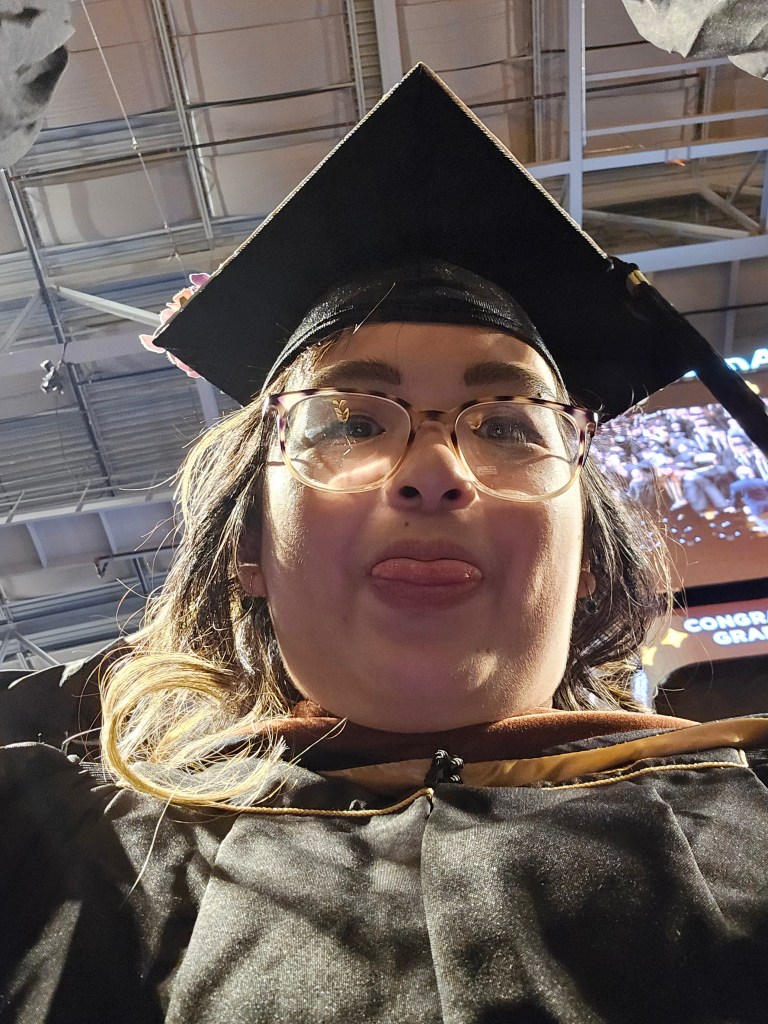A selfie I hid in the sleeve of my graduation robe because I had no pockets in my outfit. It's not at the most flattering angle, but this was me in the moment, double-chin and all.